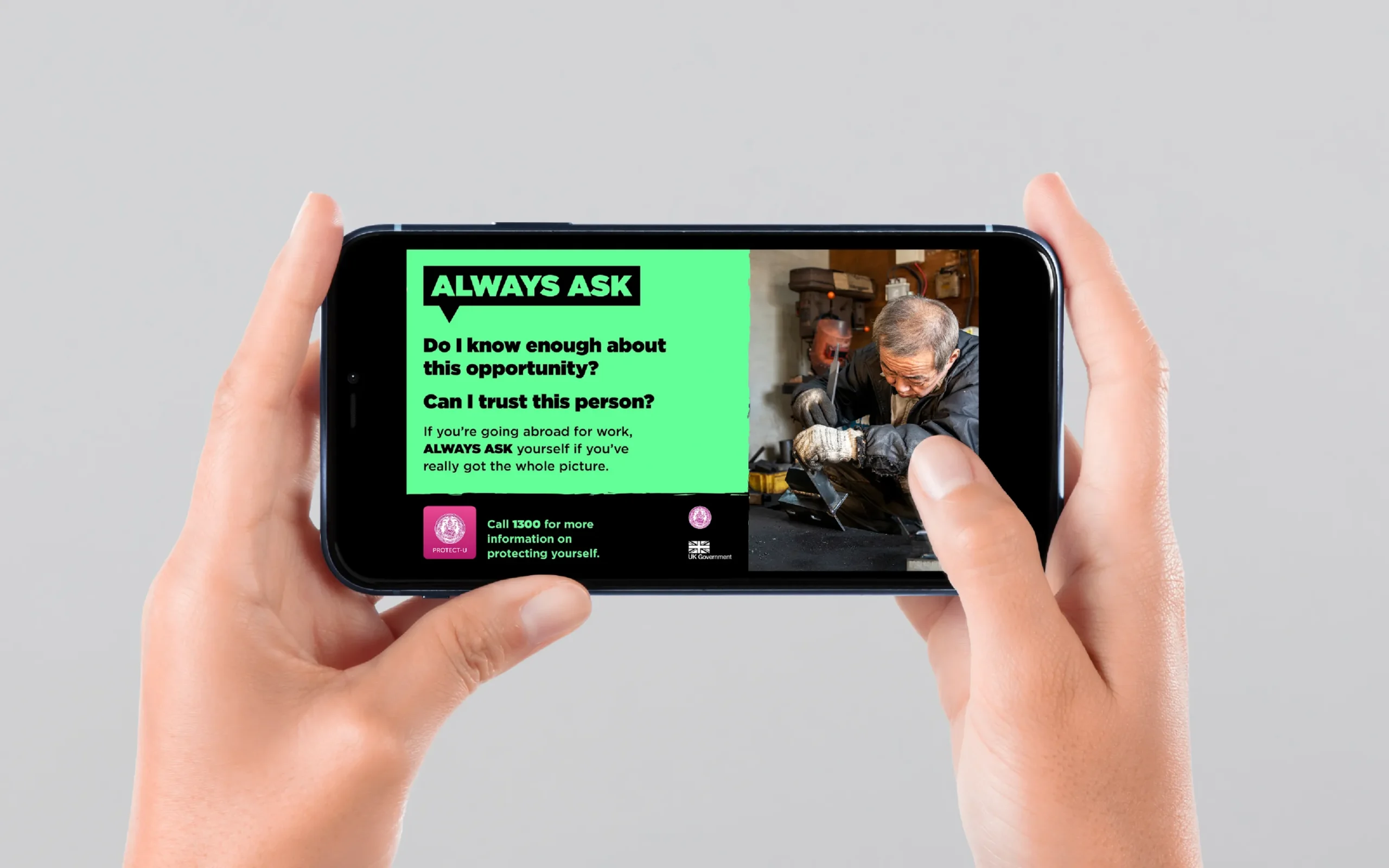 Image of campaign design displayed on a smartphone being held by a person.